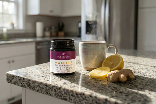 A jar, mug, lemon slices, and ginger on a kitchen countertop.